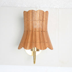 "Flora rattan wall sconce, hand-formed floral petal silhouette, full profile, white wall — Rattanology"