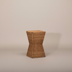 Tempo woven rattan stool with a square seat and angular hourglass-shaped body against a beige background.