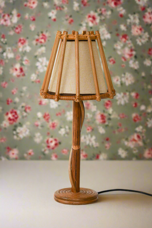 Rattan table lamp with a beige lampshade on a white background
