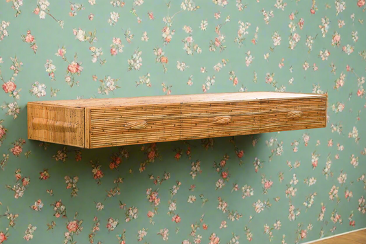 Wooden shelf against a floral-patterned wall