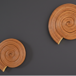 "Whorl rattan wall sconce, hand-formed spiral rattan form, full profile, dark studio— Rattanology"