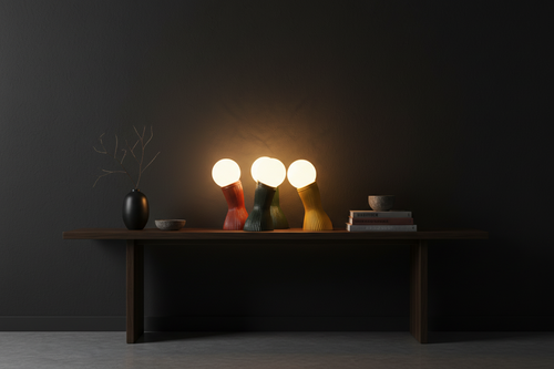 "Three Colours rattan table lamps in Deep Green, Brick Red and Yellow, lit in a dark dining room — Rattanology"